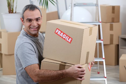 Organised storage unit with furniture and boxes in Erith